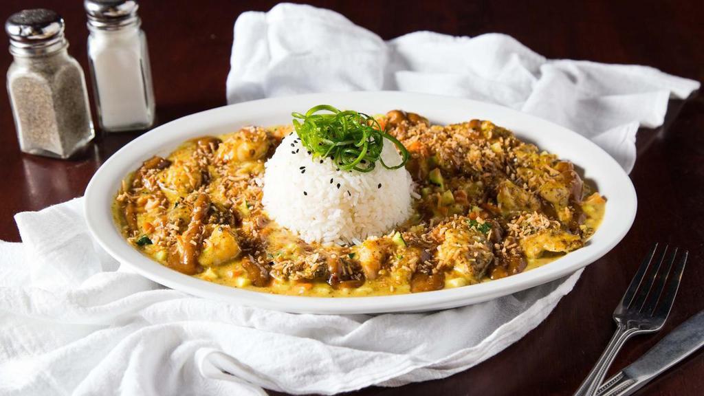 Chicken & Vegetable Curry · Tender pieces of pan-seared chicken, zucchini, and carrots in a rich coconut curry sauce. Served with white rice and topped with toasted coconut, sesame seeds, and Thai peanut sauce.