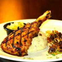 Korean Bbq Pork Chop · Hickory grilled bbq bone in pork chop topped with pineapple Pico de Gallo, over mashed potat...