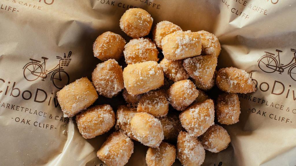 Sicilian Sfince · A basket full of Sicilian doughnuts served warm and dusted with sugar and cinnamon