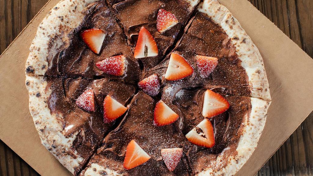 Nutella Pizza · Neapolitan style pizza crust topped with Nutella, strawberries and powdered sugar