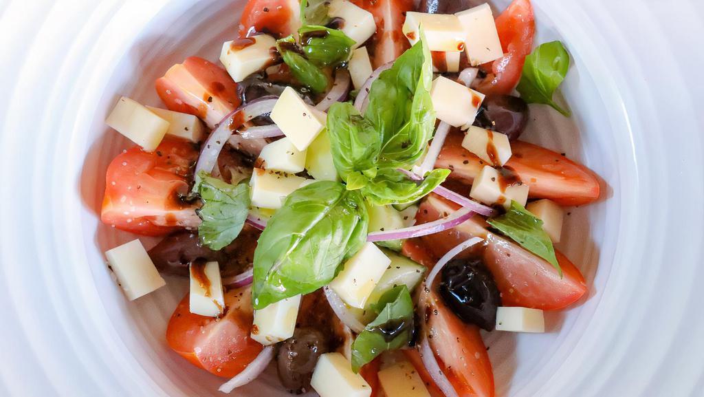 Pomodoro Salad · Tomatoes, cucumber, fresh basil, black olives, red onion, Provola Dolce, EVOO, balsamic reduction