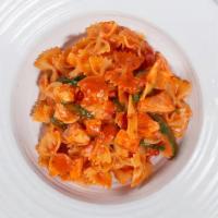 Farfalle Al Salmone · Bow tie pasta, sautéed salmon, white wine, San Marzano tomatoes, arugula, EVOO, garlic, gard...