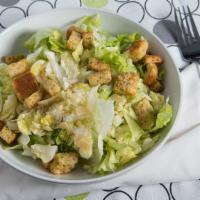 Caesar Salad · Crispy romaine lettuce tossed in our homemade caesar dressing, topped with shaved Parmesan, ...