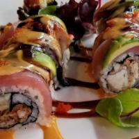 Kirin · Soft shell crab, cucumber, avocado roll topped with eel and tuna, served with eel sauce.

Th...