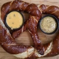 Soft Pretzel · Soft pretzel with Jack Daniels mustard and jalapeno cheese sauce.