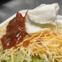 Burrito Bowl · Rice, refried beans, ground beef, lettuce, cheese, sour cream and salsa.
