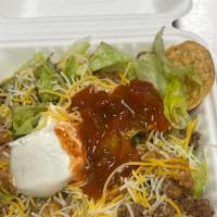 Taco Salad · Tortilla chips, refried beans, ground beef, lettuce, cheese, sour cream and salsa.