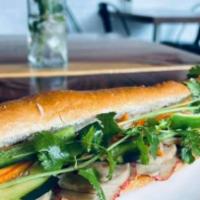 Banh Mi · Toasted baguette with butter spread along with choice of protein, cucumber, cilantro, jalape...