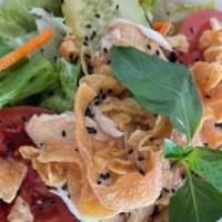 Chinese Chicken Salad · Salad consisting of slices of chicken, romaine lettuce, cucumbers, and tomatoes accompanied ...