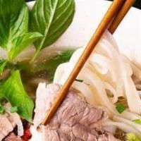 Beef Pho · Served in a bowl with a specific cut of flat rice noodles in clear richly Vietnamese style b...