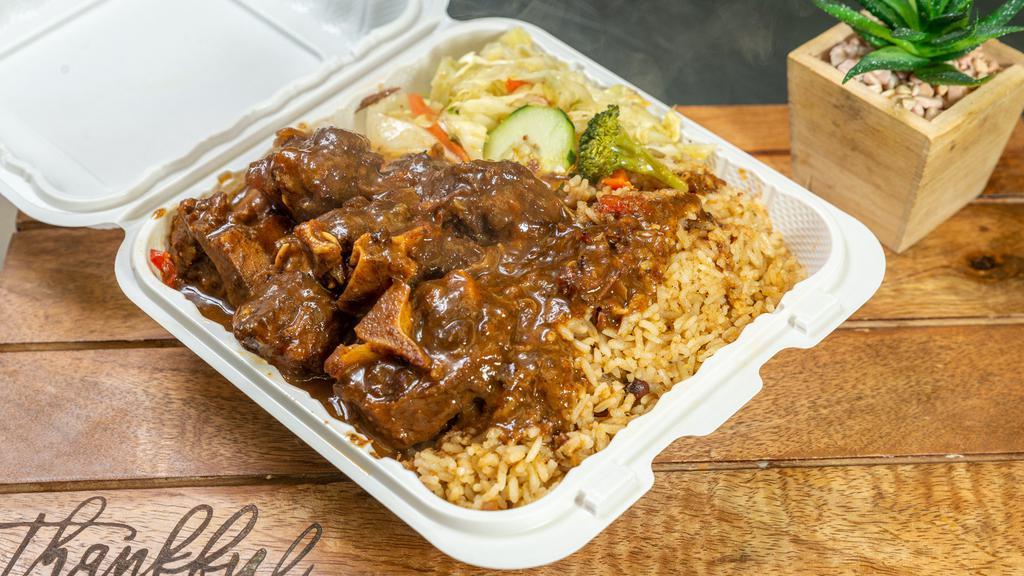 Oxtail · Oxtail with choice of two sides: rice and beans and cabbage