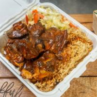 Brown Stew Chicken · Delicious homemade brown stew chicken
Served with two sides rice and beans and cabbage