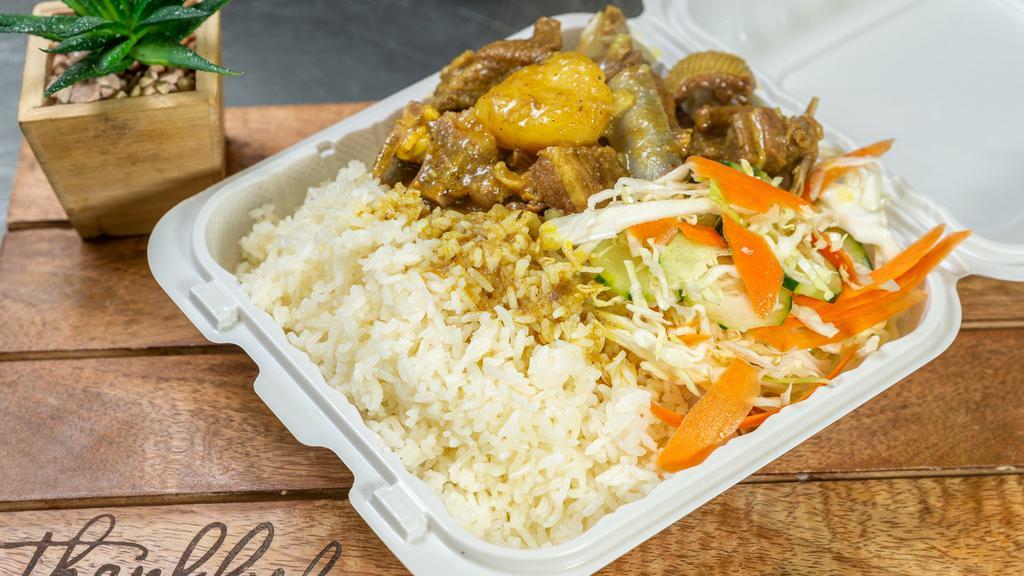 Curry Goat · Curry Goat with choice of two sides: rice and beans and cabbage