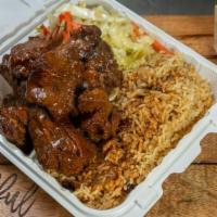 Brown Stew Pork · Brown stew pork, choice of two sides: rice and beans and cabbage