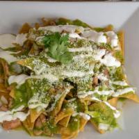 Chilaquiles Verdes · Corn tortillas cooked with green sauce topped with cheese and served with choice of protein