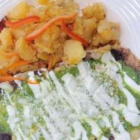 Huevos Rancheros · Tortillas topped with avocado salsa, sour cream and cotija cheese comes with home fries