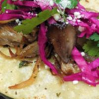 2 Tacos De Hongos  · Grilled shitake mushroom, caramelized onions, coitja cheese, cilantro and red cabbage