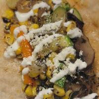 Tacos De Vegetales · Sauteed zucchini, corn, and mushrooms topped with sour cream and cheese.
