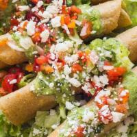Tacos Dorados De Papa · 3 fried rolled corn tortillas stuffed with potatoes topped with sour cream and queso cotija ...