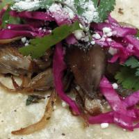 2 Tacos De Hongos · cremini Mushrooms, garlic, caremlized onions, pickled cabbage, cotija cheese and cilantro