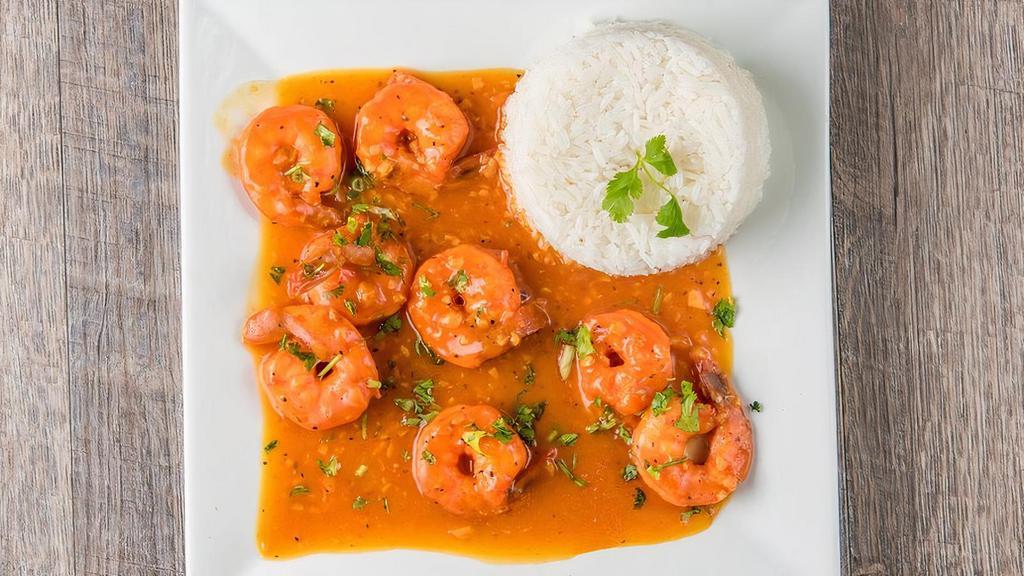 Camarones Al Ajillo · Shrimp in garlic sauce served with two options of either French fries, green salad, sweet plantain.
