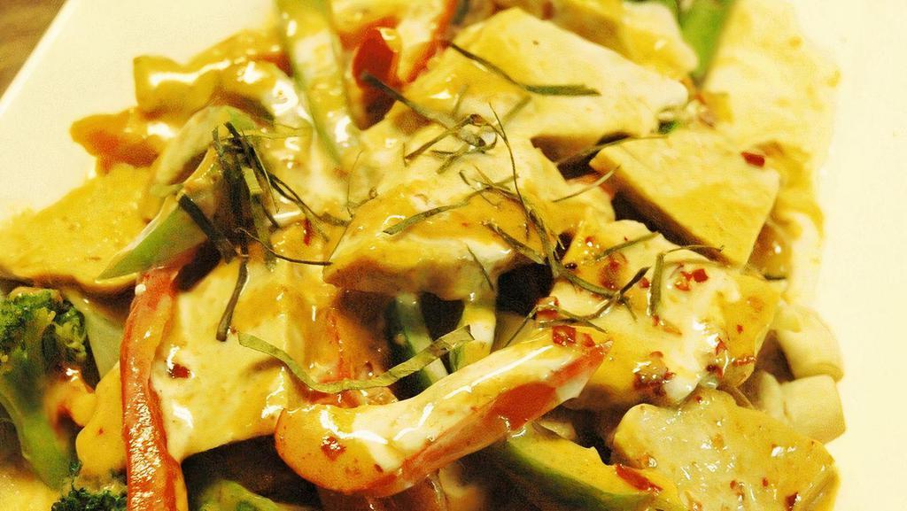 Asparagus Hunsa · Fried tofu, asparagus, bell peppers, mushrooms, and seasonal vegetables. Cooked in panang curry, topped with fresh basil.