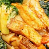 Phad See-Iew · Wide noodles stir-fried with fried tofu, broccoli, carrots, and Chinese broccoli in see-iew ...