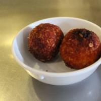 Arancini With Eggplant · Two fried risotto balls filled with smoked mozzarella, and eggplant.