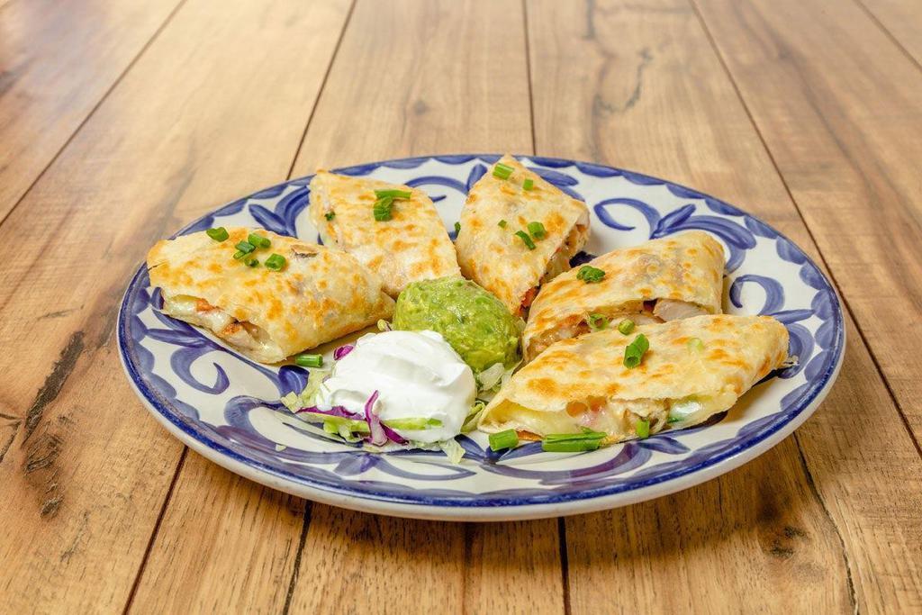 Quesadilla - Chicken · Grilled with a hint of garlic until crisp and golden brown with grilled chicken, pico de gallo, salsa picante, guacamole and sour cream.