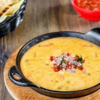 Queso Dip · Two cheese blend, pico de gallo, roasted pasilla peppers and cilantro.  Served with warm tor...