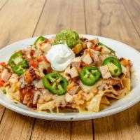 Nachos Supremos - Chicken · Chicken on a mound of warm chips, melted cheese, refried beans and guajillo chile sauce topp...