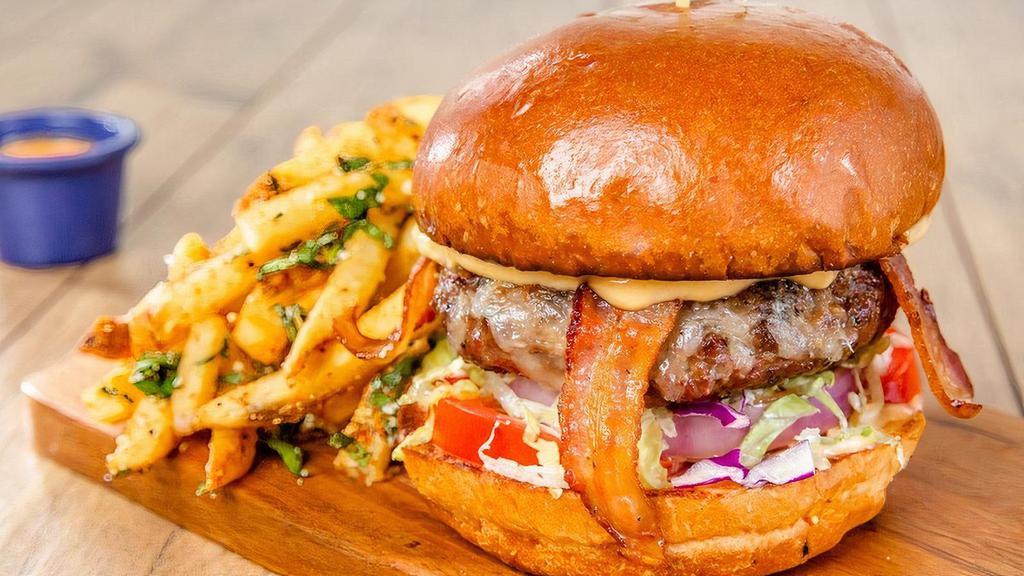 Who Song & Larry'S Bacon Burger · Seasoned beef patty on a brioche bun, bacon, jack cheese, lettuce, red onion and chipotle aioli. Served with papas calientes and red pepper dip.