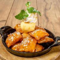 Sopapillas · Mexican pastry tossed in caramel sauce and topped with vanilla ice cream and cinnamon whippe...