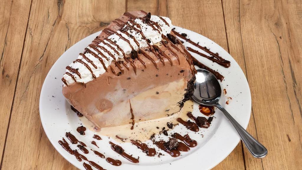 Mudd Pie · A popular dessert brought back!! Our Mudd Pie is made in house with a delicious chocolate cookie crumb crust, layered with premium coffee and chocolate ice cream, topped with chocolate sauce and cinnamon whipped cream.