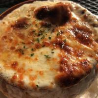 French Onion Soup · Robust broth, sautéed onions and garlic toast topped with Swiss and mozzarella cheese.