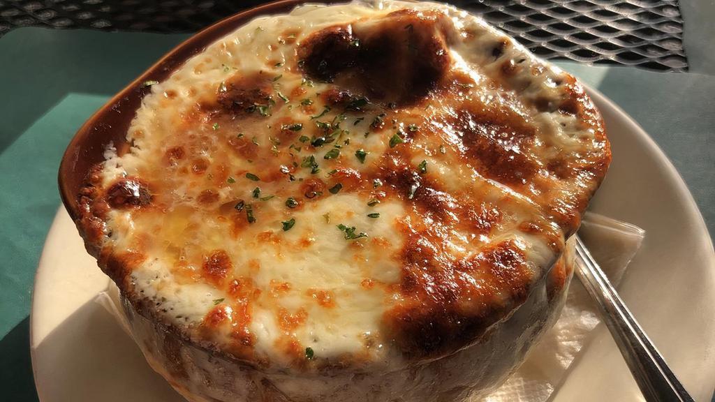 French Onion Soup · Robust broth, sautéed onions and garlic toast topped with Swiss and mozzarella cheese.
