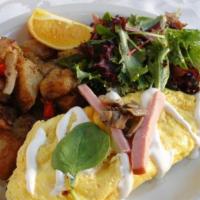 The Whitney Omelet · Three egg omelet with ham, mushrooms, spinach, and creme fraiche served with home-fried pota...