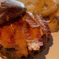 The American Burger · Your choice of a 1/4 lb. Angus burger or chicken breast served in a toasted pretzel bun. Top...