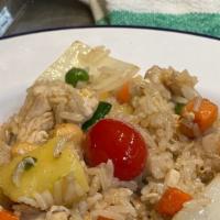 Pineapple Fried Rice · Fried rice with choice of meat,egg, onions, cherry tomatoes, pineapple chunks, peas and carr...