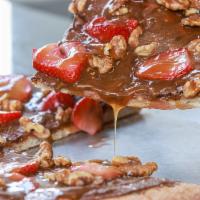 Nutella Pizza · Nutella |  Strawberries | Candied Walnuts | Drizzled w/ Caramel.