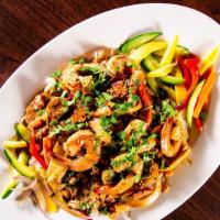 Shrimp Agave · Sautéed shrimp, onions and peppers, tequila and pepper cream sauce. Served with rice and veg...