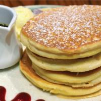 Tall Stack Buttermilk Pancakes (4) · Four Pancakes garnished with Powdered Sugar and served with Butter and Maple Syrup