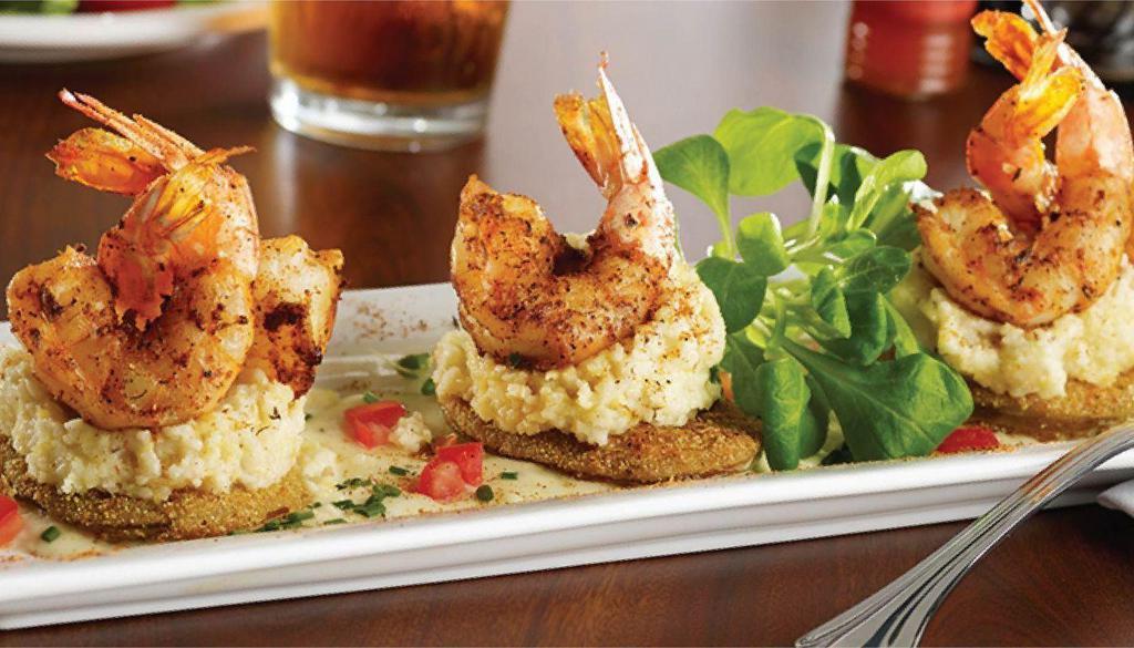 Get Your Grits On · Jumbo Blackened Shrimp or Blackened Salmon  on Fried Green Tomatoes, Stone Ground Grits with Diced Bacon & Roasted Corn Emulsion, dusted with Cajun Spice