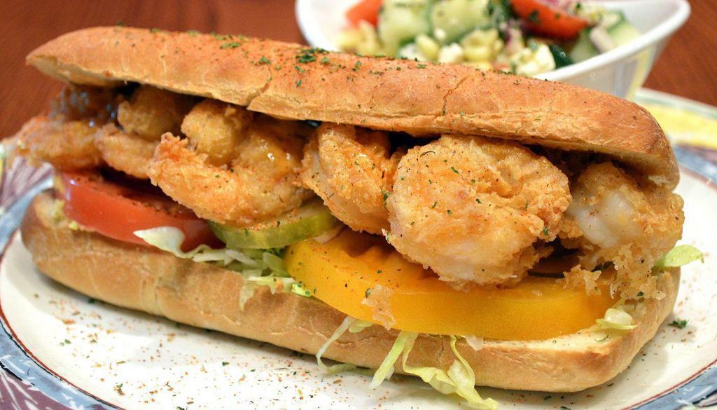 Shrimp Po’ Boy · Fried Shrimp, Shredded Iceberg Lettuce, Red & Yellow Tomatoes, Red Onion, Pickles & Chipotle Aioli on Ciabatta, dusted with Cajun Spice, served with choice of side