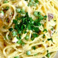 Spaghetti Carbonara · Pancetta, egg yolks, green peas, Reggiano.