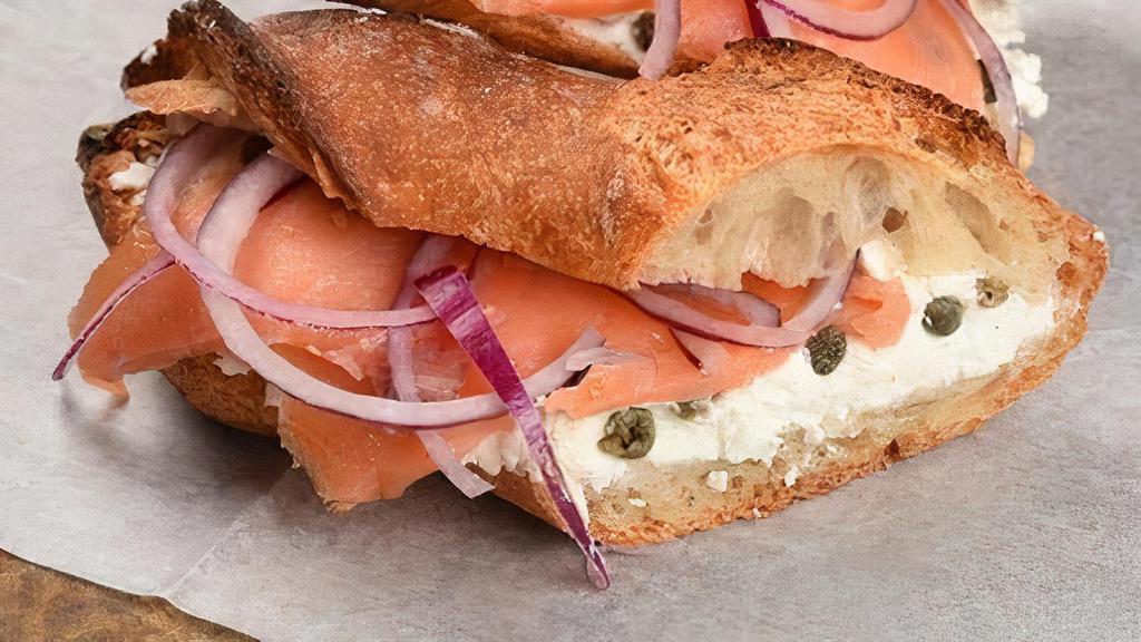 Smoked Salmon Sandwich · Smoked salmon, fresh goat cheese, capers & onion with freshly baked baguette.