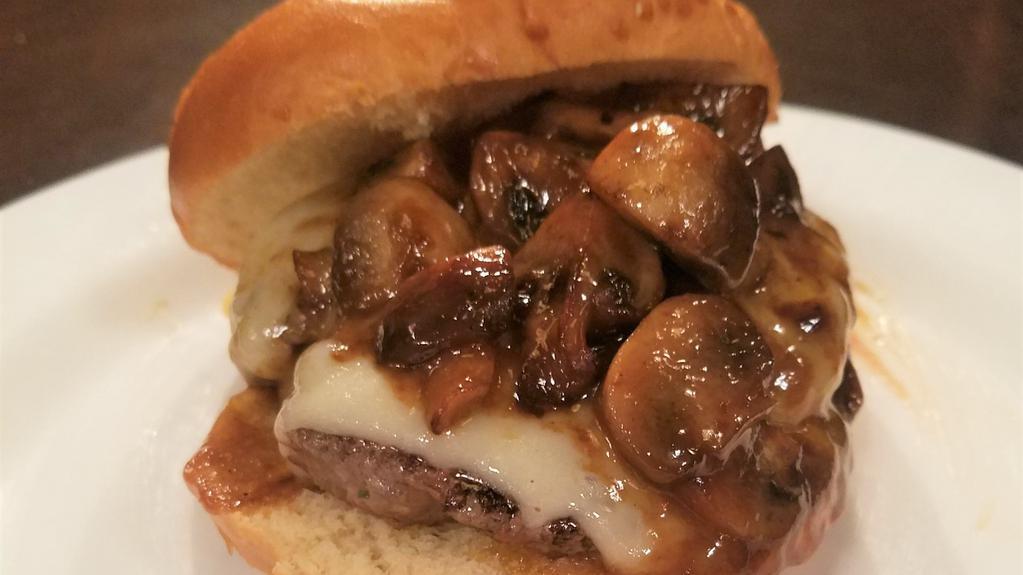 Smothered Mushroom And Swiss Burger · Charbroiled burger topped with melted swiss cheese then piled high with our signature smothered mushrooms cooked in their delicate gravy.