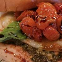 Caprese Chicken Sandwich · Grilled chicken breast served on a bed of spinach, fresh pesto, topped with oven-roasted tom...