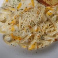 Fettuccine Alfredo · Fettuccine noodles coated with a blanket of creamy alfredo sauce, topped with a blend of che...