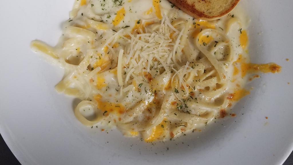 Fettuccine Alfredo · Fettuccine noodles coated with a blanket of creamy alfredo sauce, topped with a blend of cheese, and baked to a golden brown. Add protein for an additional charge.